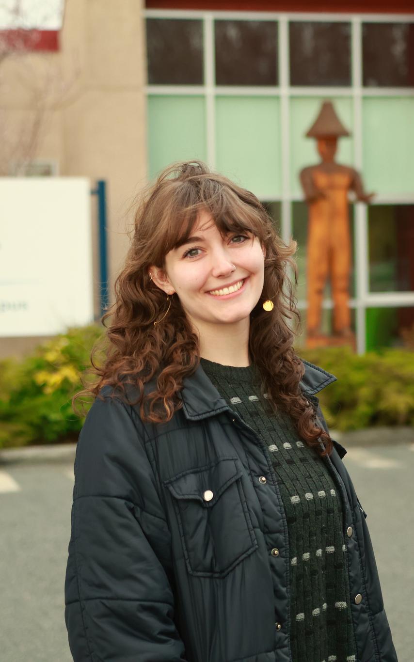 Student Brianna Desilets standing in front of VIU tiwsemawtxw campus